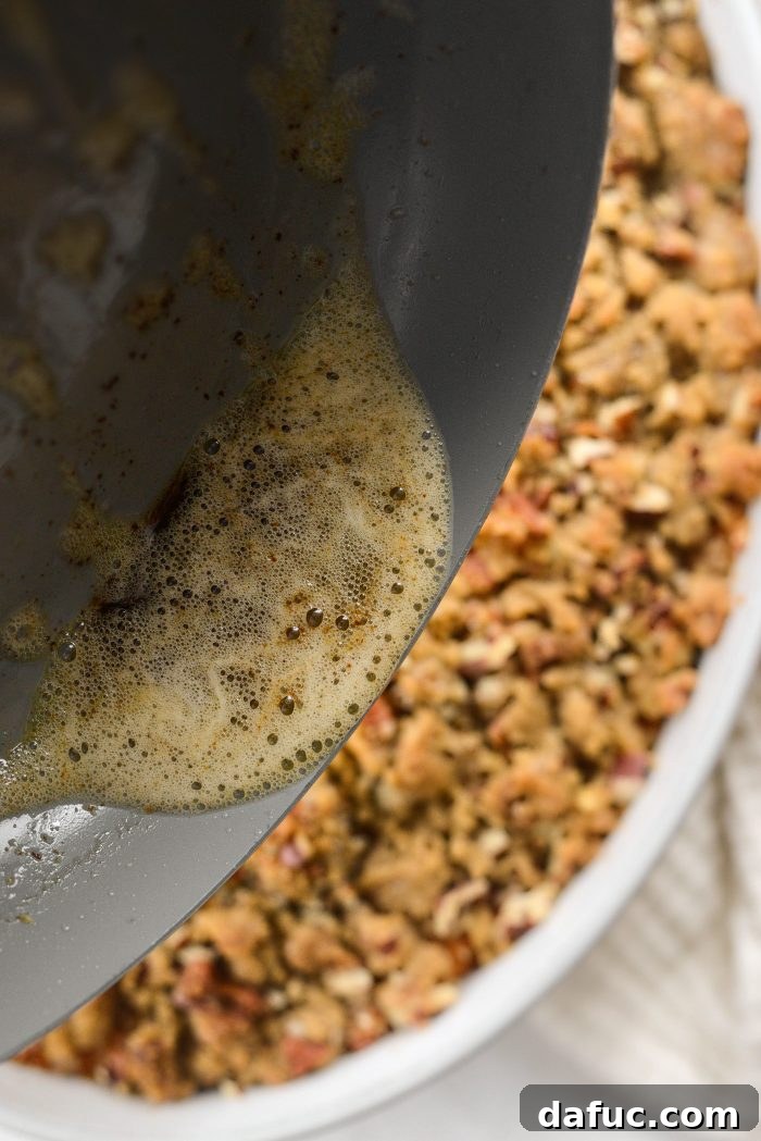 Removing sage leaves and pouring sage brown butter over sweet potato casserole