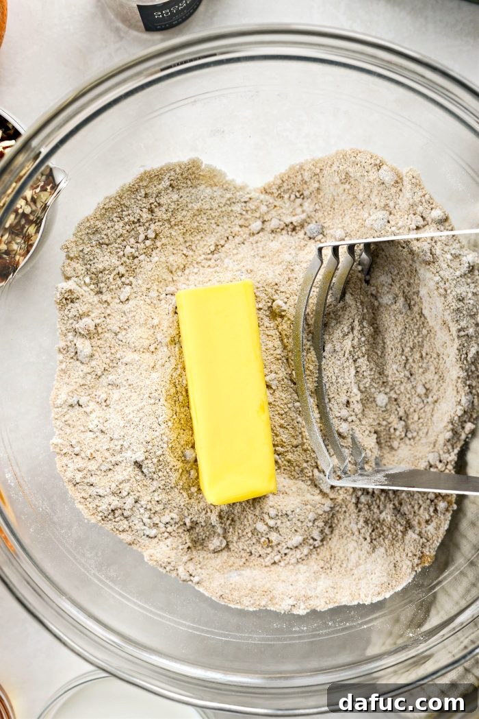 Adding unsalted butter to dry ingredients for crumb topping