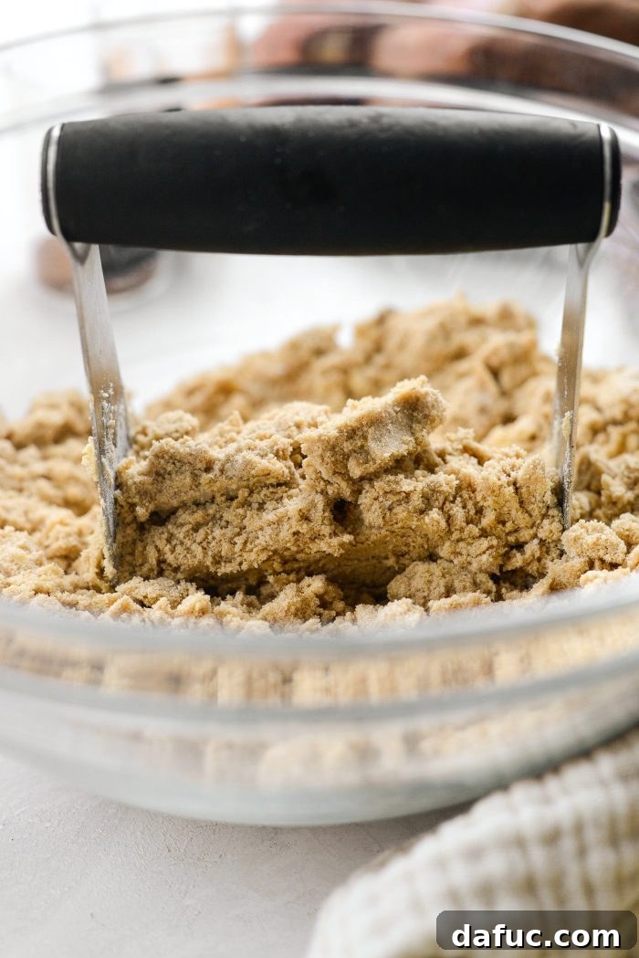 Cutting butter into dry ingredients with a pastry blender for streusel
