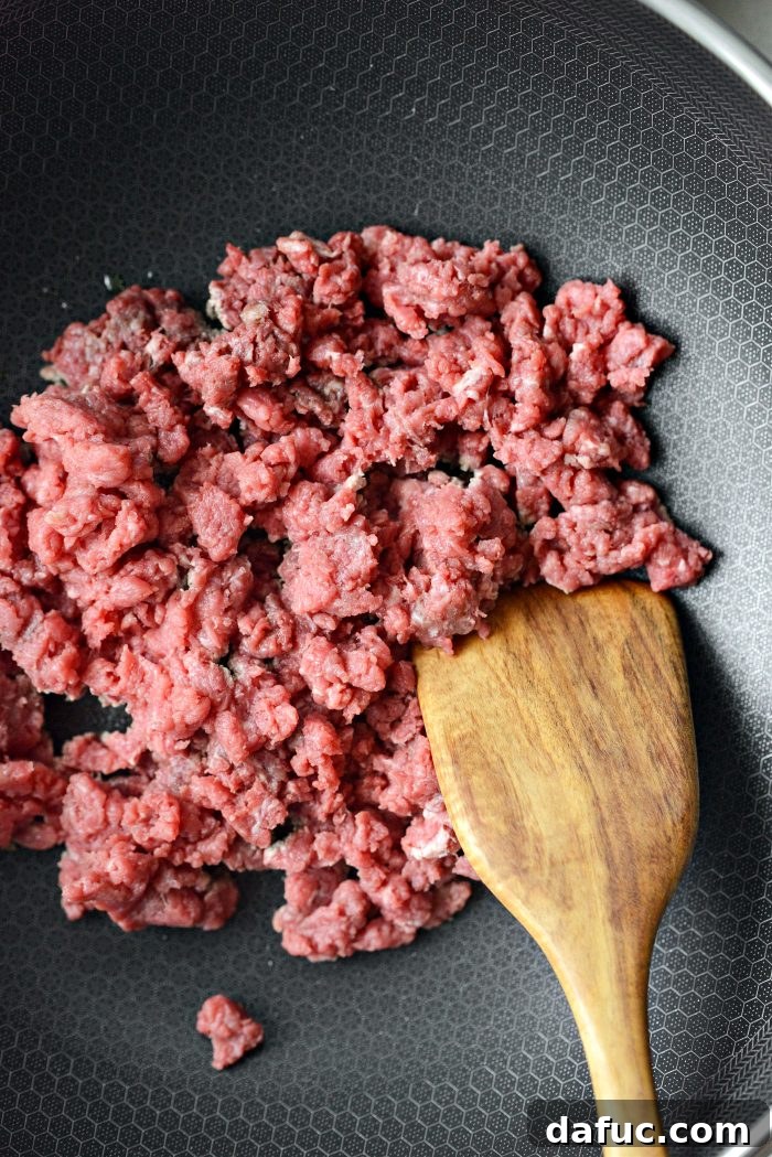 Spicy Sriracha Steak Lettuce Cups 9 Adding chopped cube steak to a hot pan