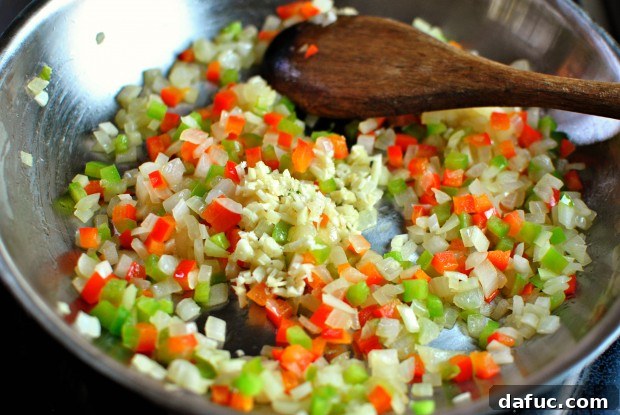Adding garlic to softened vegetables