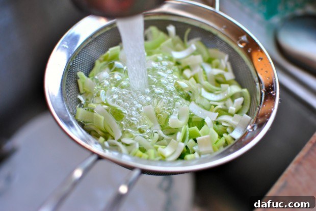 Silky Pancetta, Leek, and Sweet Pea Mac & Cheese 5 Rinsing leeks in a strainer
