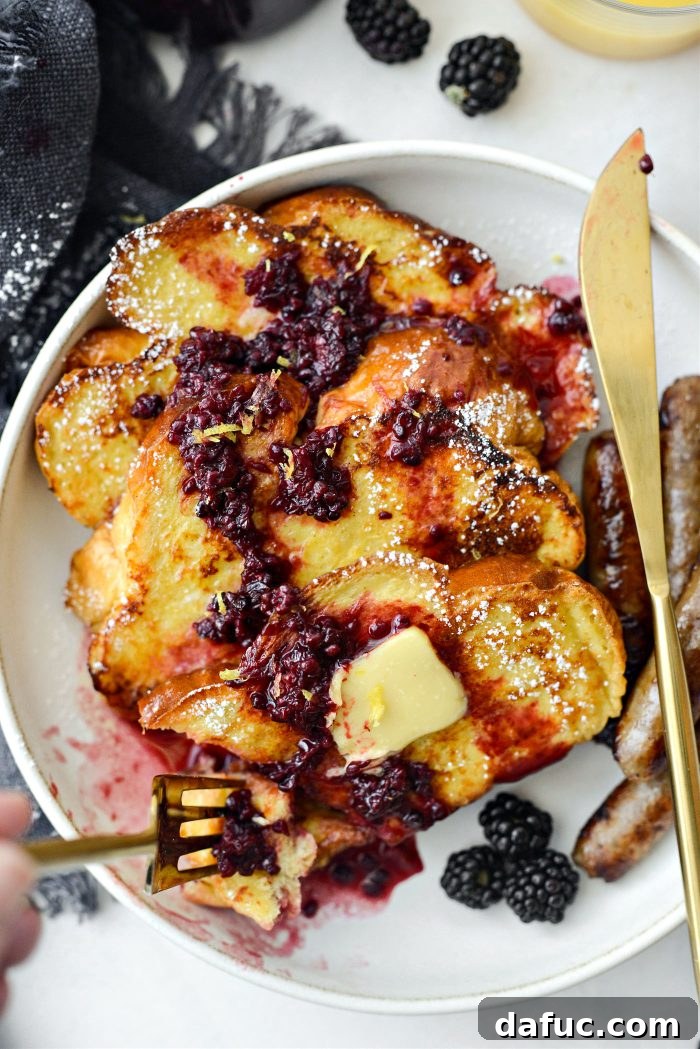 Sourdough French Toast with Berry Compote 3 Two plates of Buttermilk French Toast, drizzled with maple blackberry sauce and lemon zest