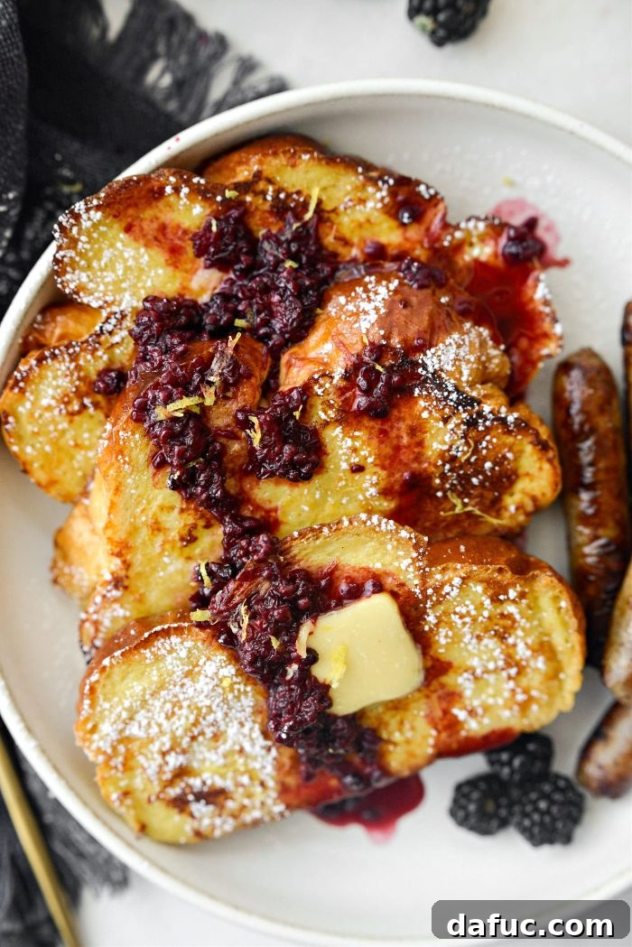 Sourdough French Toast with Berry Compote 22 Buttermilk French Toast with a fork, ready to eat