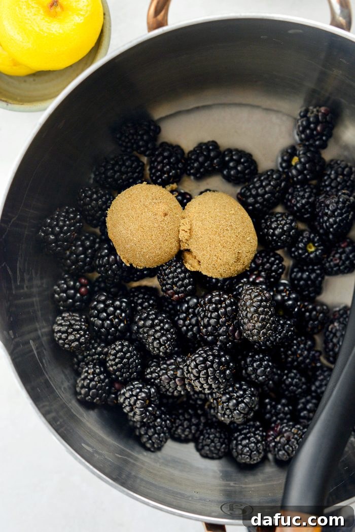 Sourdough French Toast with Berry Compote 5 Adding blackberries, brown sugar, water, and lemon juice to a saucepan