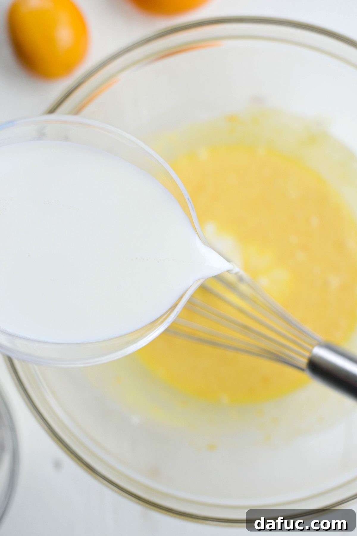 Pouring milk into the batter