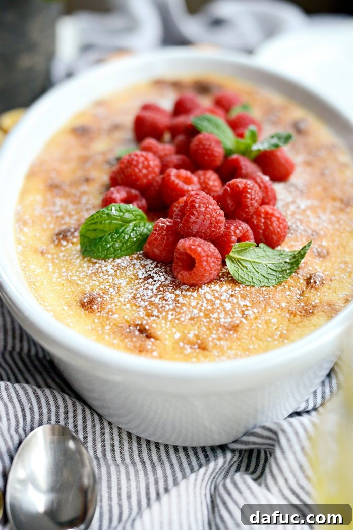 Meyer Lemon Pudding Cake garnished with raspberries