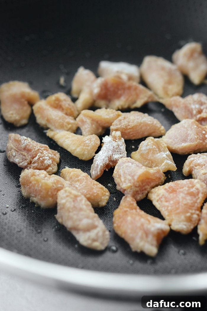 Sticky Sweet Bourbon Chicken 11 Cooking chicken in batches in a wok