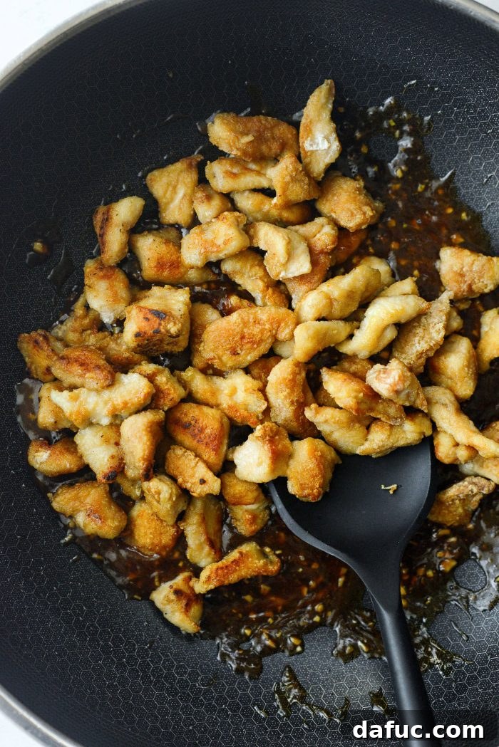 Sticky Sweet Bourbon Chicken 15 Adding cooked chicken back into the thickened sauce