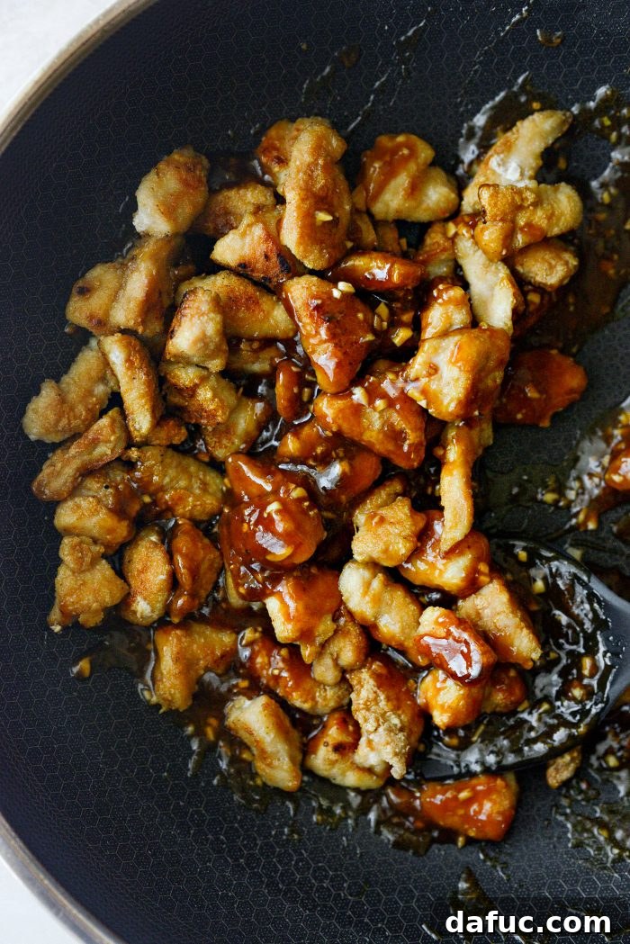 Sticky Sweet Bourbon Chicken 16 Tossing Bourbon Chicken to coat with sauce