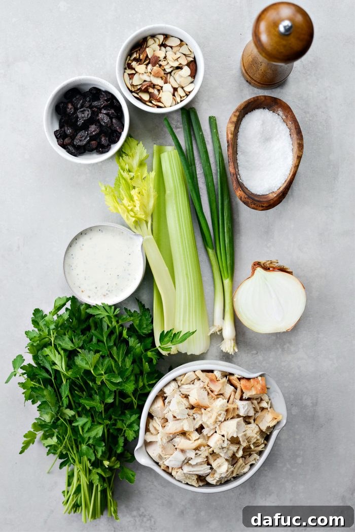 A selection of fresh ingredients for Cherry Toasted Almond Chicken Salad, laid out on a clean surface.