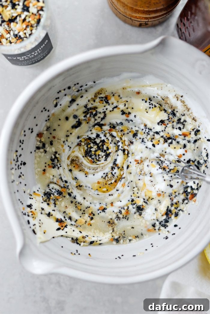 Whisked dressing ingredients, showing a smooth and creamy consistency, ready to be added to the salad.