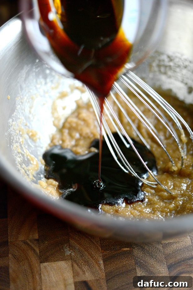 Golden Molasses Chews 6 Adding molasses to the mixture of sugars and butter.