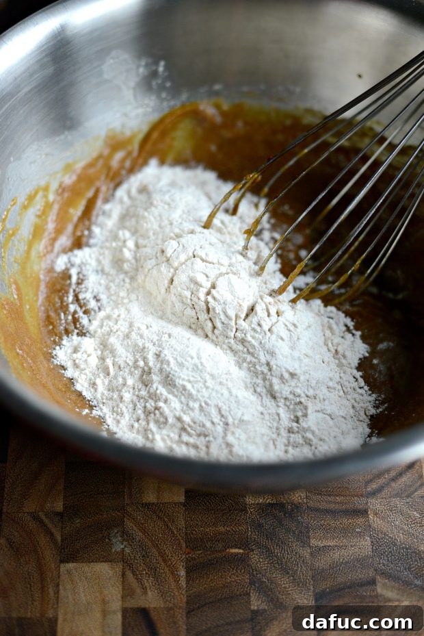 Golden Molasses Chews 9 Adding all dry ingredients to the wet mixture for cookie dough.