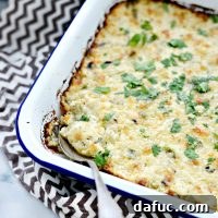 Irresistibly gooey Cheesy Chicken Dip ready for scooping with tortilla chips.