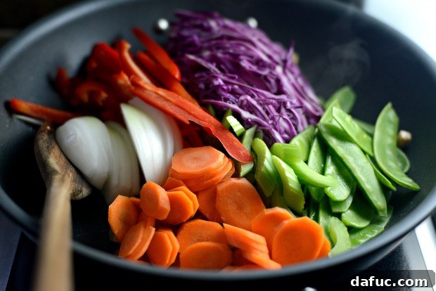 Adding vegetables to a wok