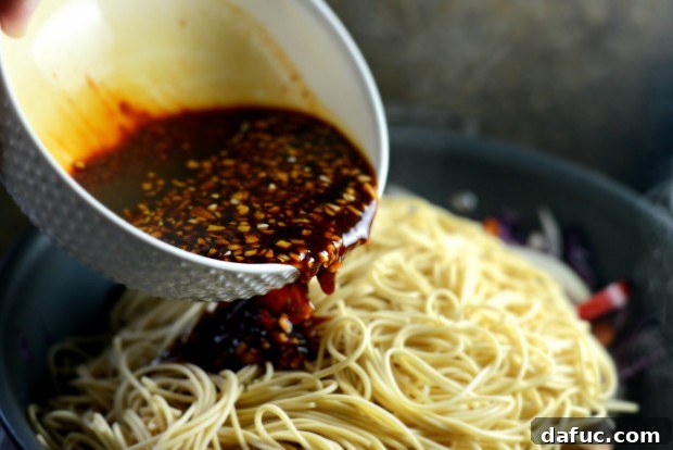 Adding stir-fry sauce to the wok