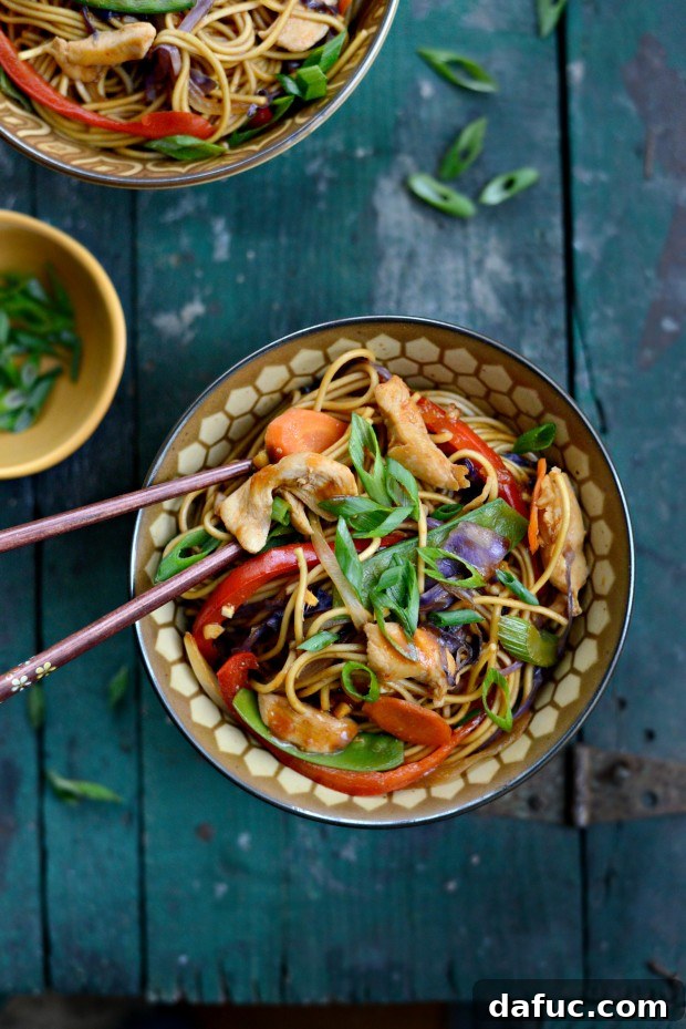 Serving Chicken Rainbow Vegetable Stir-fry with chopsticks
