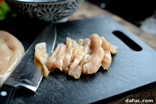 Sliced raw chicken breasts for stir-fry