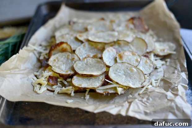 Crumbled crispy bacon sprinkled over the cheese and potato layer.