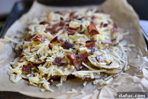 Second layer of crispy potato rounds added on top of the bacon and cheese.