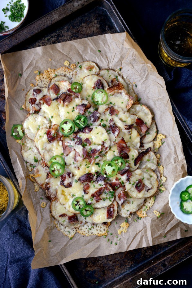 Irish Nachos topped with fresh snipped chives and thinly sliced jalapeños, ready to be served.