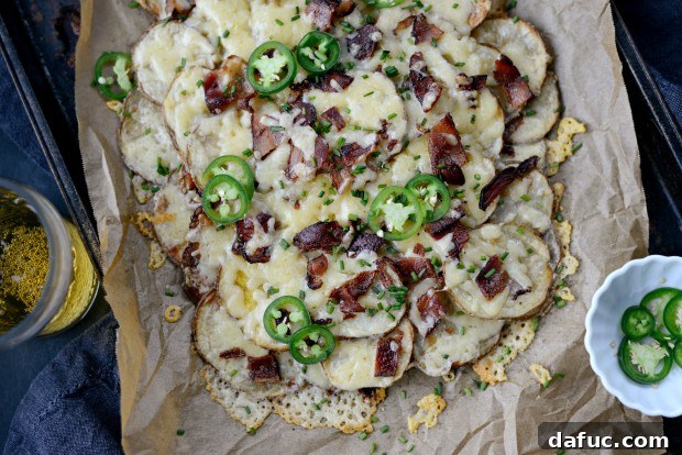 A vibrant, close-up shot of Irish Nachos, highlighting the textures and colors of the melted cheese, bacon, and fresh green toppings.