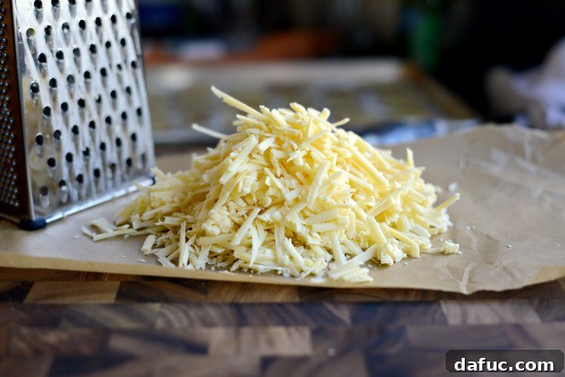 Grated Irish white cheddar and Dubliner cheeses ready for layering on Irish Nachos.