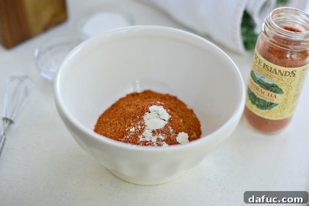 Crunchy Sriracha Garlic Kale Crisps 8 Adding Sriracha Seasoning to Kale Chip Mixture