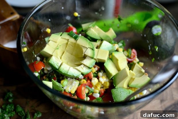 Salsa ingredients being tossed together in a bowl
