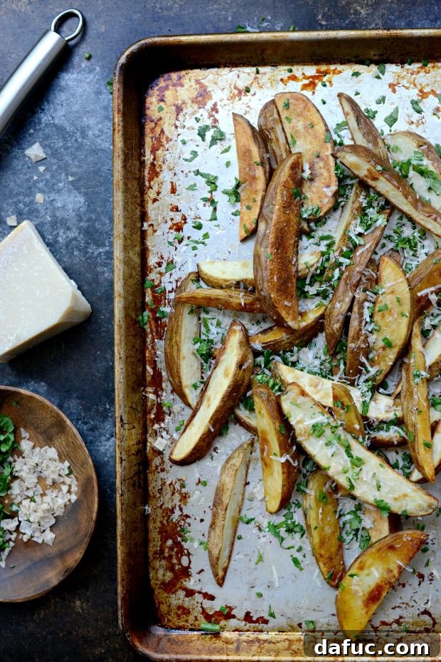 Close-up of golden crispy oven fries with herbs