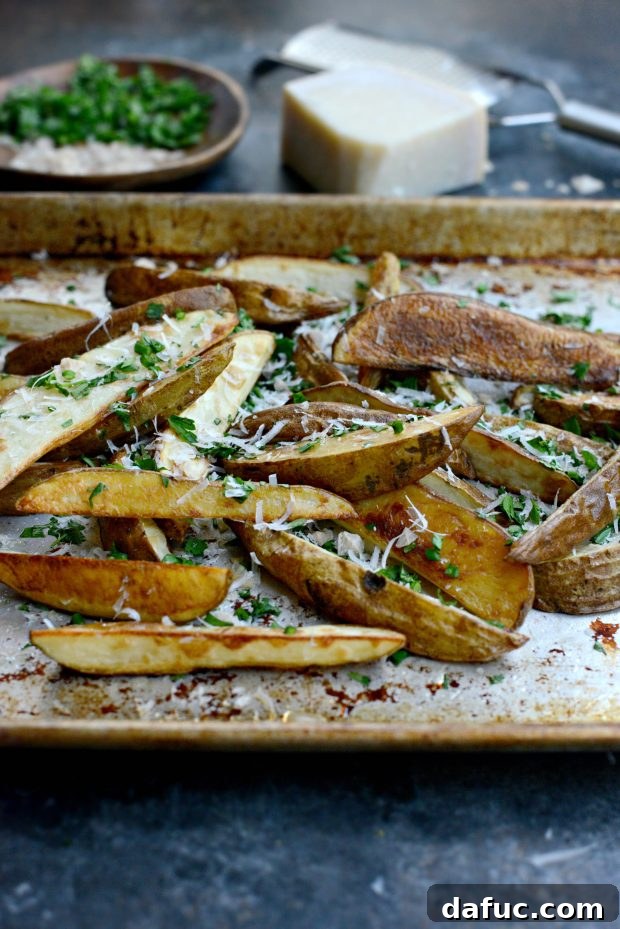 Tray of seasoned russet potato wedges before baking