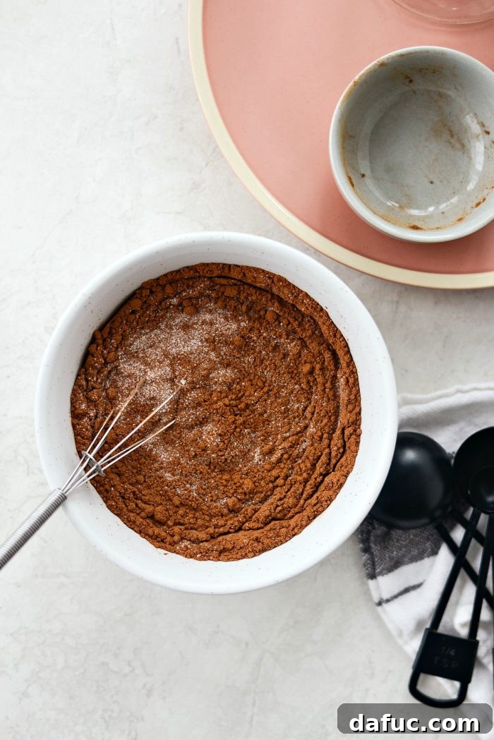 Mixing Granulated Sugar and Ground Cinnamon for a homemade blend. Easy, best cinnamon sugar recipe from Simply Scratch.
