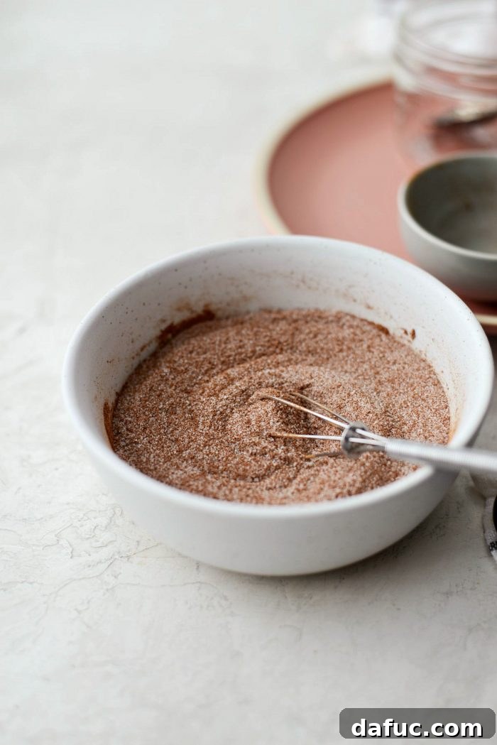 Freshly made Homemade Cinnamon Sugar in a glass jar. Easy, best spice blend recipe from Simply Scratch, ready to use.