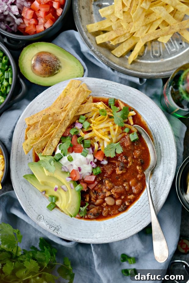 Finished Turkey Taco Beer Chili with various toppings in a bowl