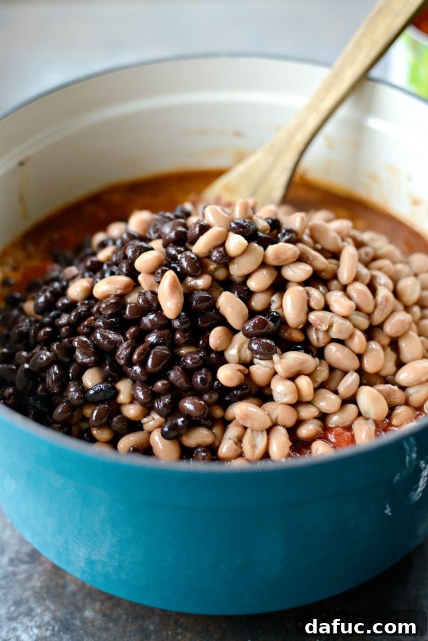 Adding rinsed and drained beans to the chili pot