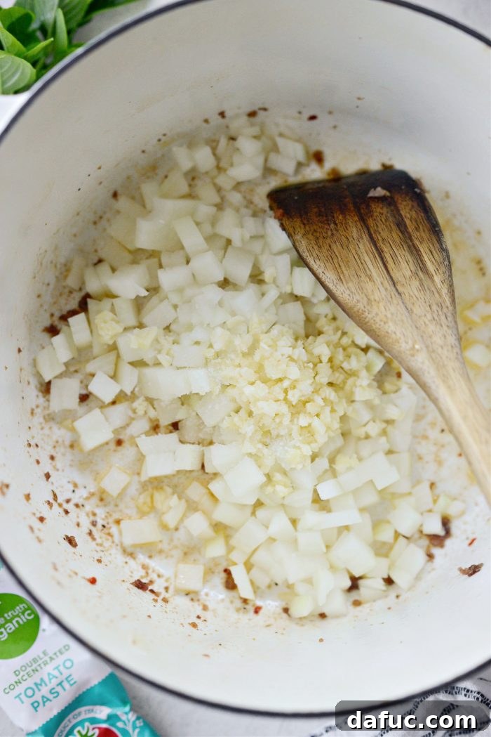 Effortless One-Pan Spaghetti 8 onions and garlic in pot with sausage fat