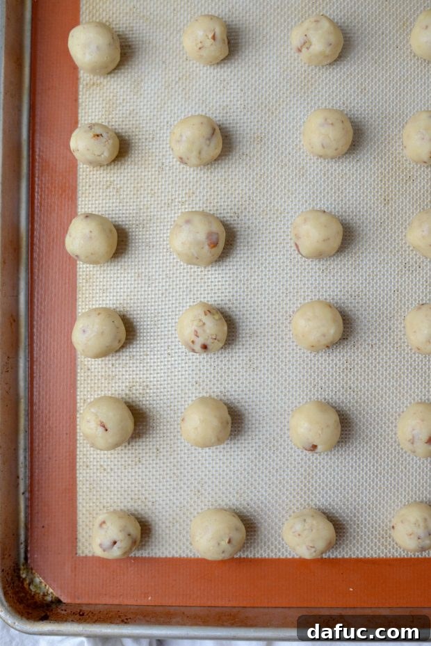 Pecan Dreamscape 6 The mixed Pecan Dreams Snowball Cookie dough in a stand mixer bowl.