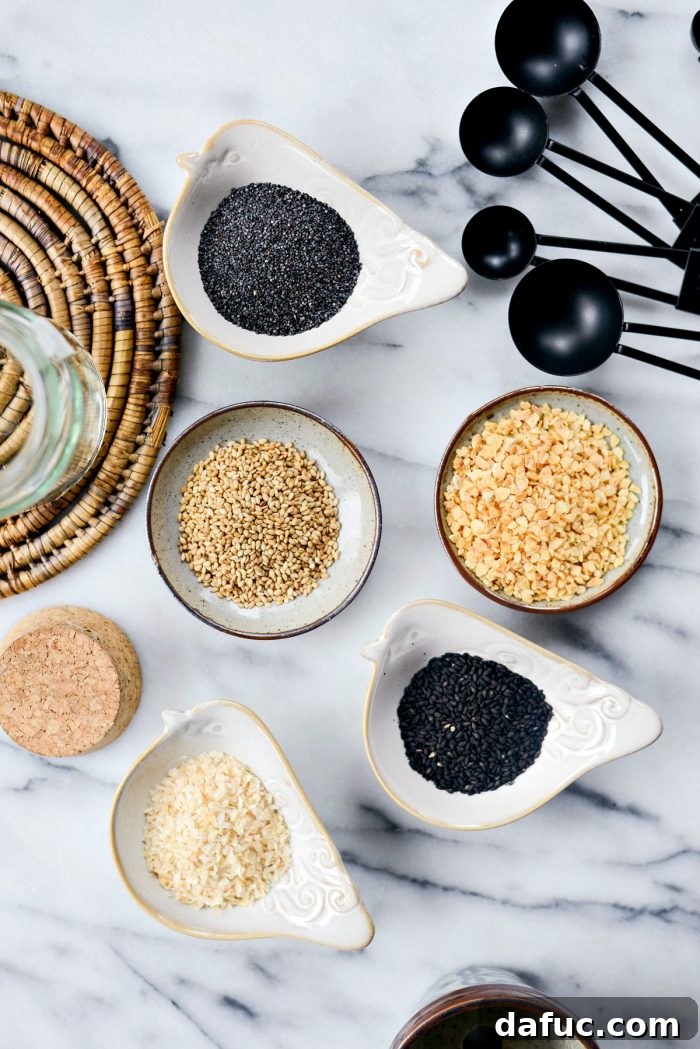 Kitchen's Secret Weapon 4 Close-up of the individual ingredients for Everything Bagel Seasoning: poppy seeds, dried minced garlic, dried minced onion, toasted sesame seeds, and black sesame seeds