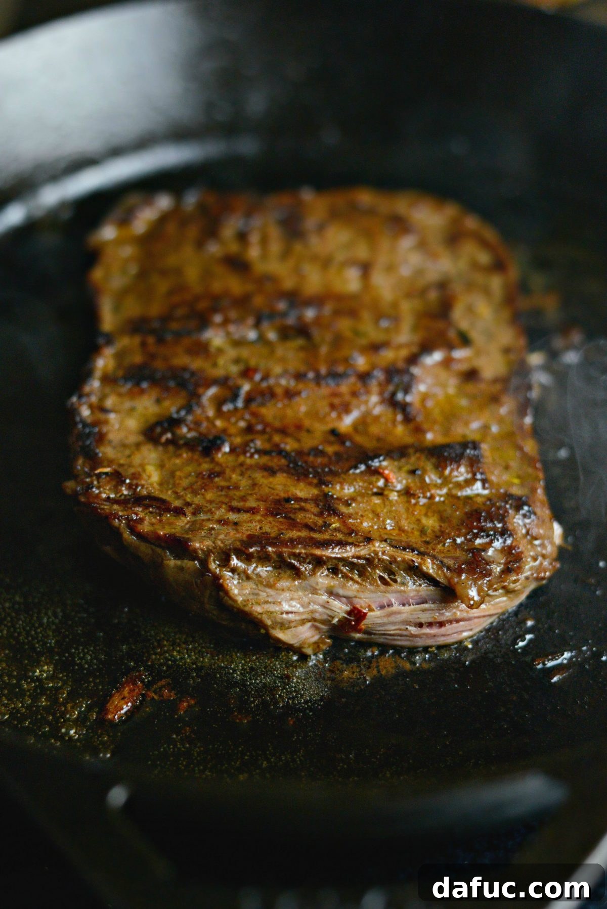 Cooking marinated skirt steak in a cast iron skillet