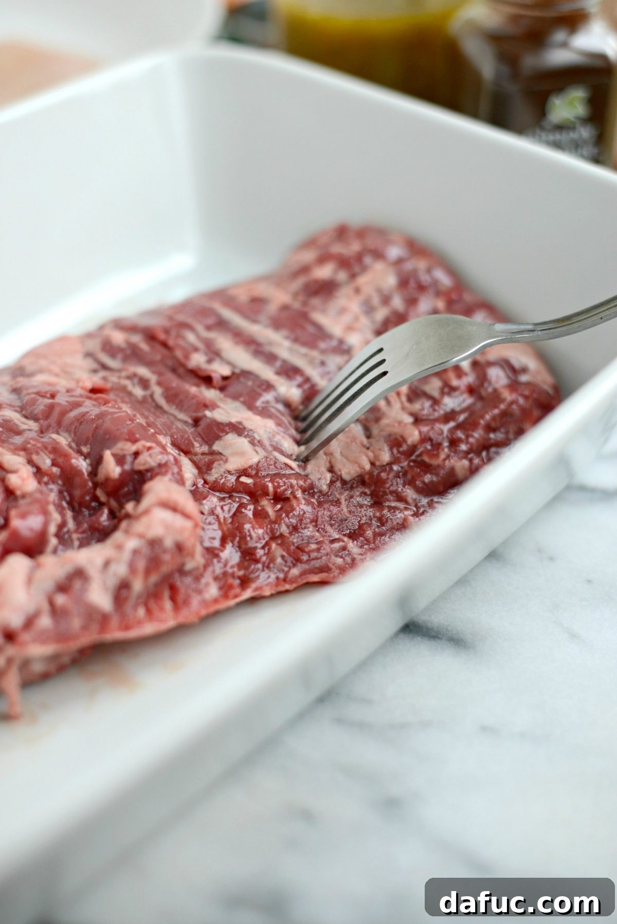 Pricking skirt steak with a fork to help with marinade absorption