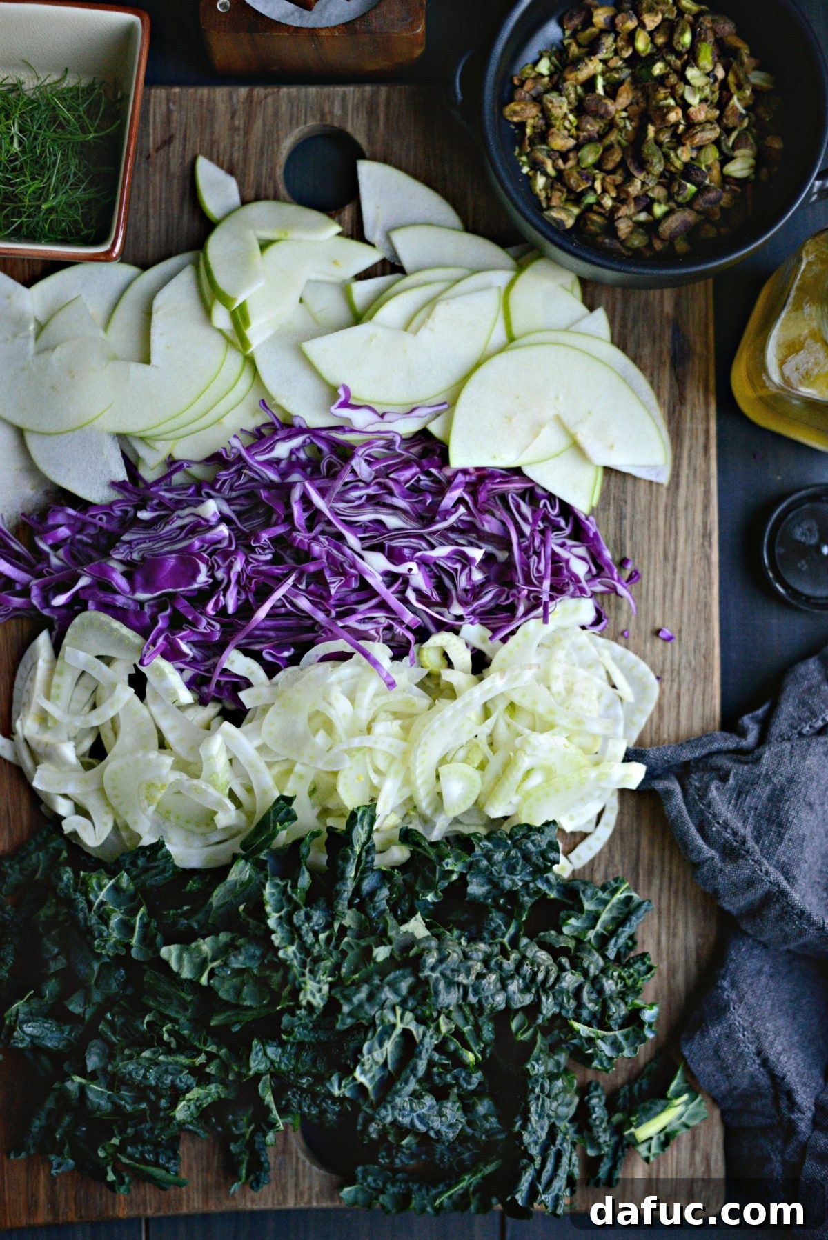 Prepped ingredients for Kale, Fennel and Apple Salad, including chopped kale and sliced vegetables.