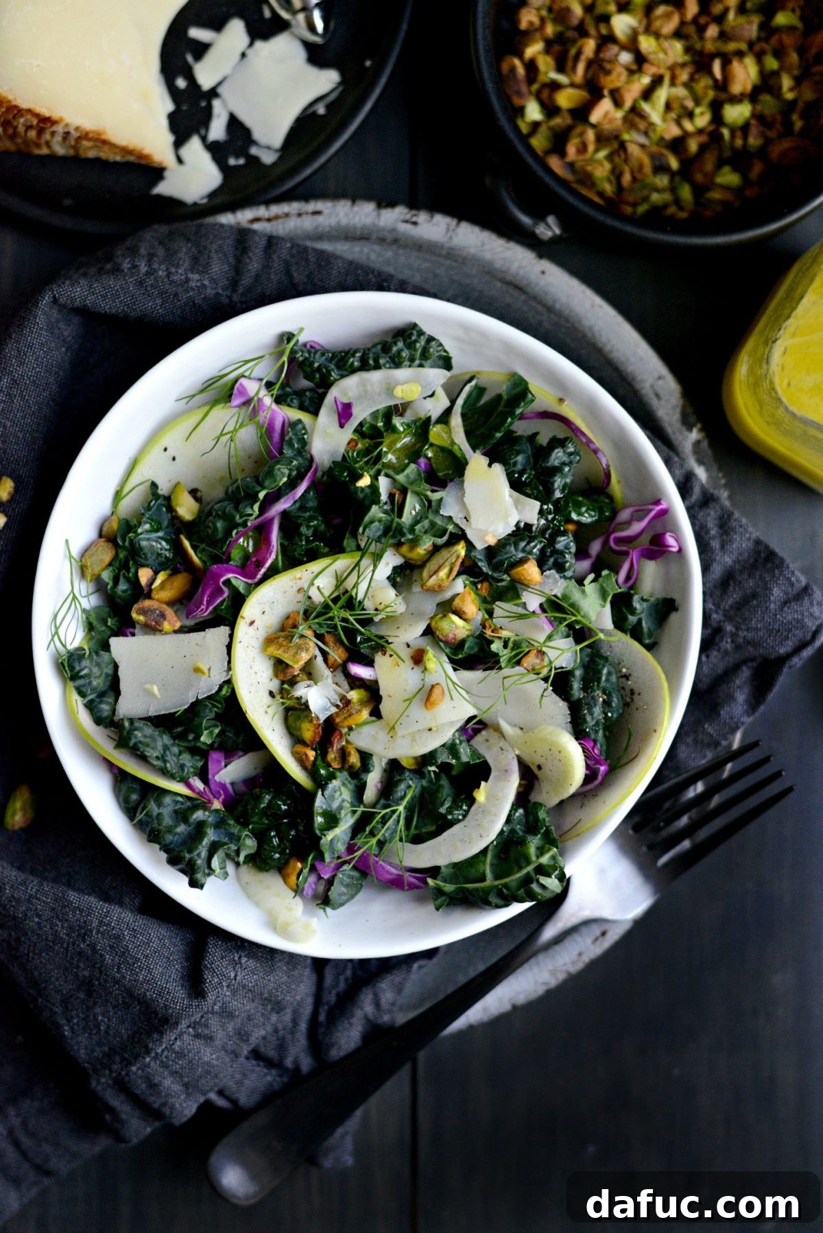 Plated Kale, Fennel and Apple Salad garnished with pistachios and Pecorino.