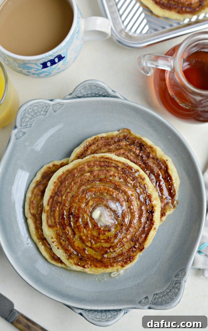 Dreamy Cinnamon Swirl Stacks 2 Delicious Cinnamon Swirl Pancakes stacked with syrup