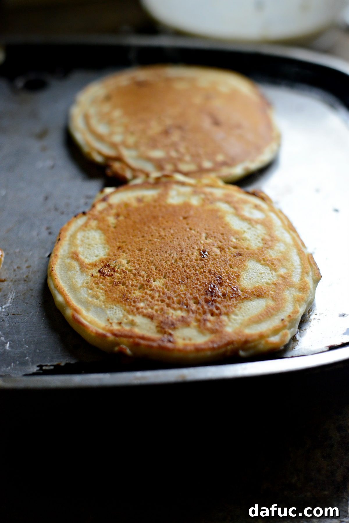 Dreamy Cinnamon Swirl Stacks 15 Flipping the swirled pancake to continue cooking