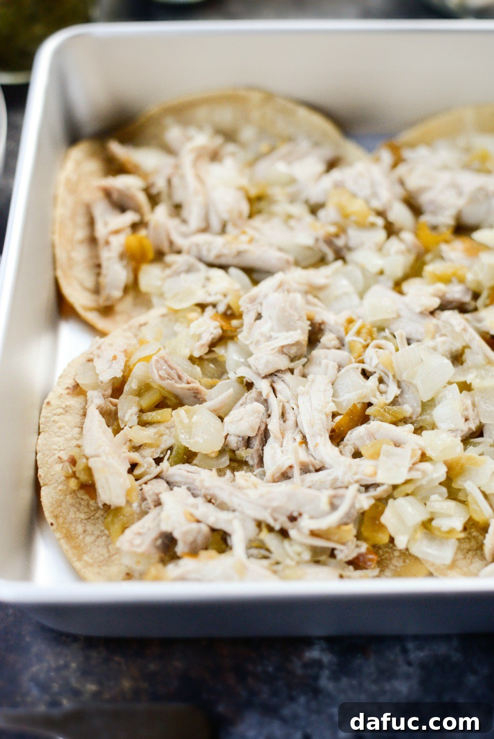 Green Chile Chicken Tortilla Bake 8 First layer of shredded chicken mixture spread over tortillas