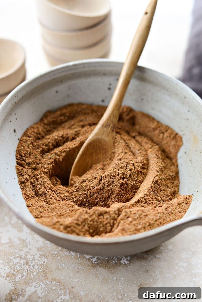 DIY Shawarma Spice Mix 8 Several small glass jars of Homemade Shawarma Seasoning on a wooden surface