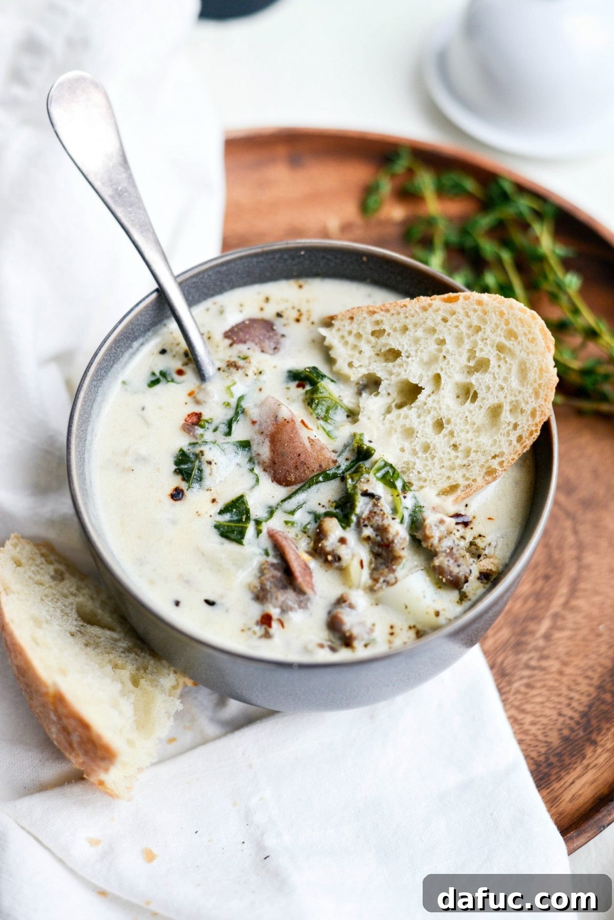Close-up of Creamy Potato, Sausage and Kale Soup in a bowl, showcasing the rich texture and ingredients.