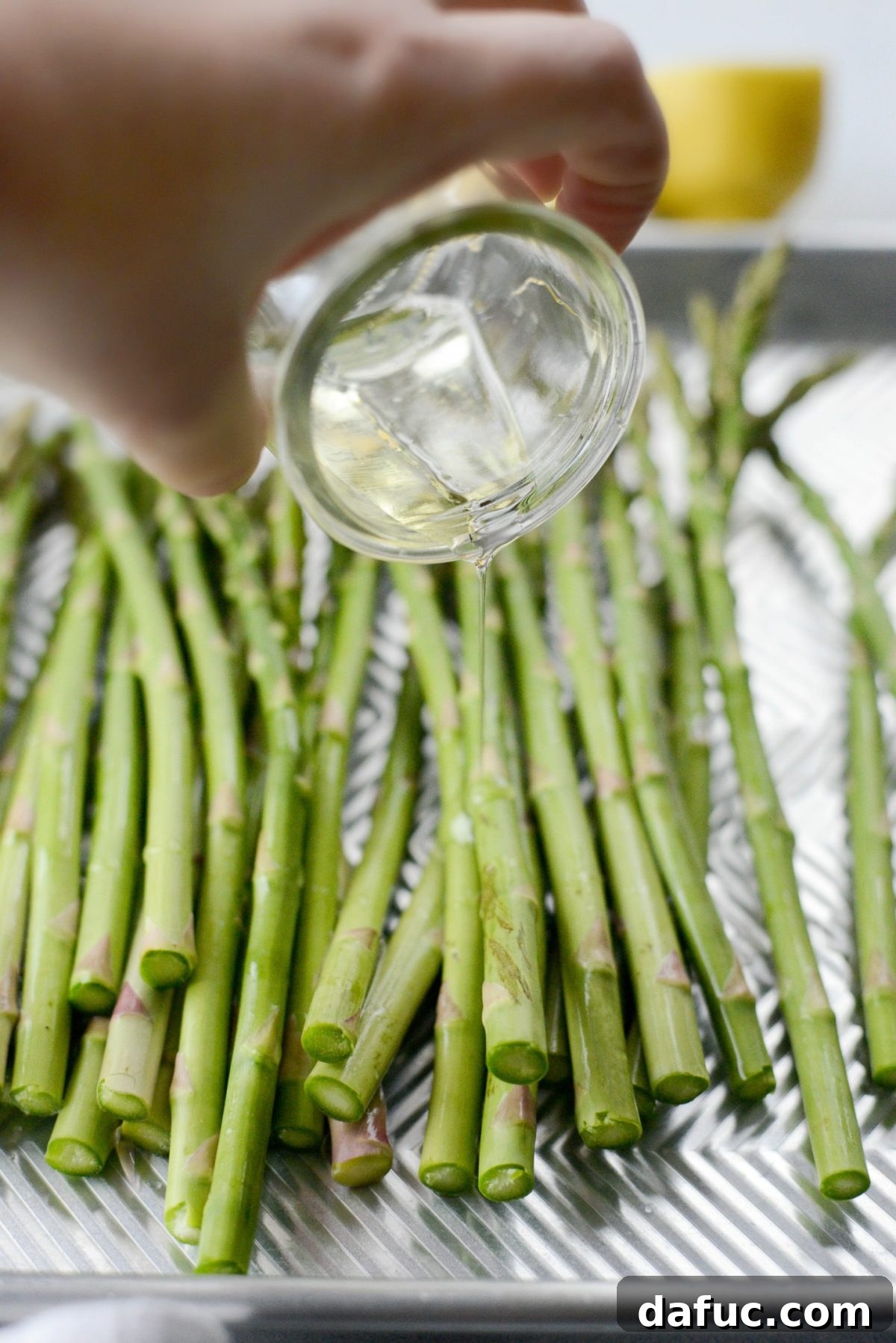 Zesty Garlic Parmesan Asparagus Roast 7 Drizzling olive oil over asparagus
