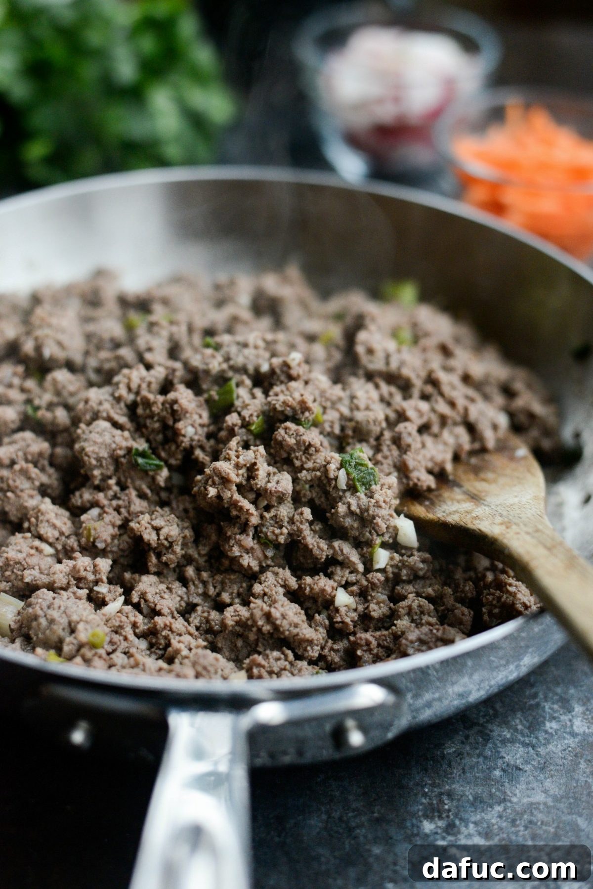 Cooking lean ground beef until browned, then draining the fat.